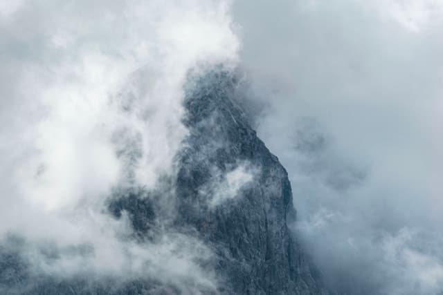 A mountain peak shrouded in thick clouds